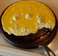frying eggs on a cast iron griddle